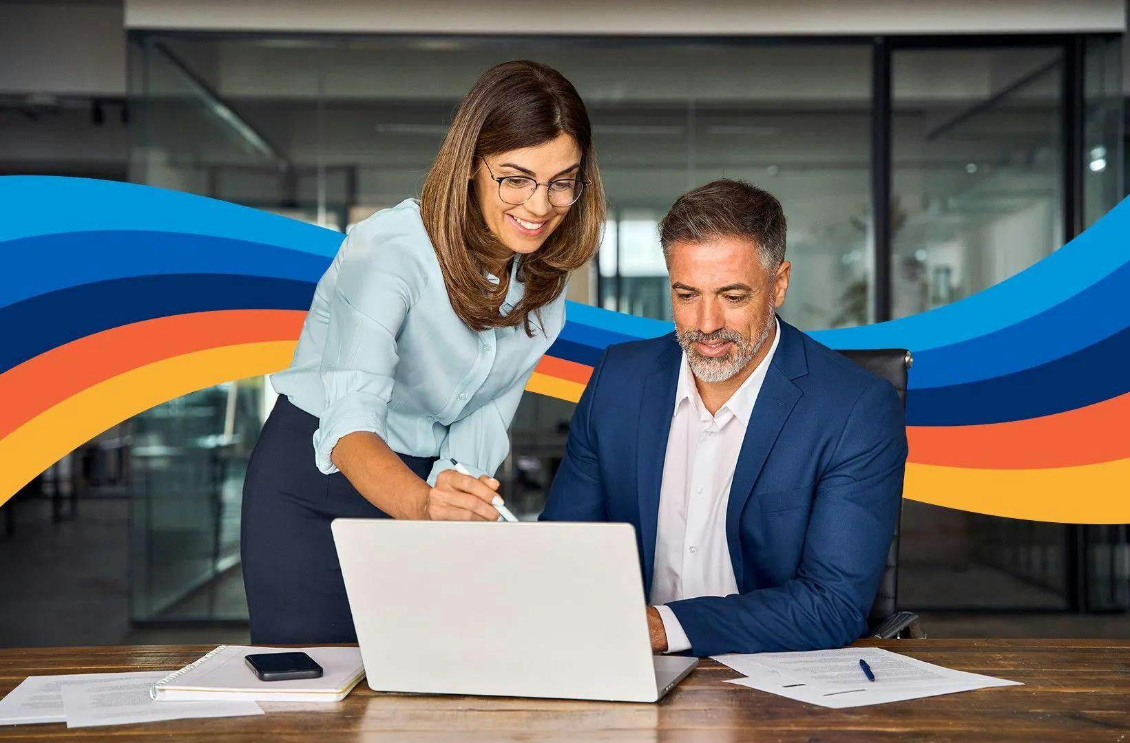 Two colleagues discussing something on computer